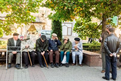 a group of people sitting next to each other on a bench