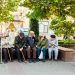 a group of people sitting next to each other on a bench
