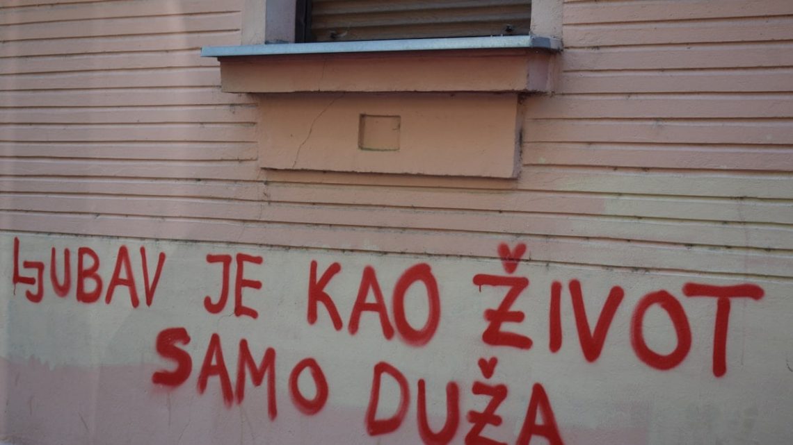Red graffiti on a building wall