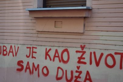 Red graffiti on a building wall