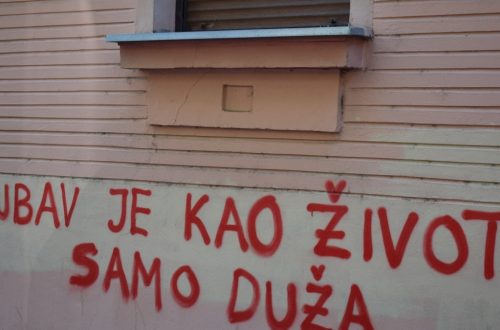 Red graffiti on a building wall