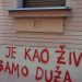 Red graffiti on a building wall