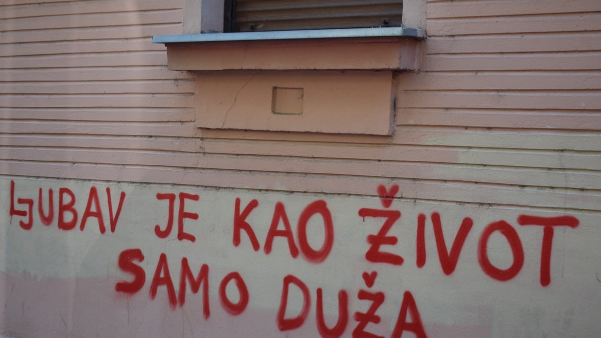 Red graffiti on a building wall