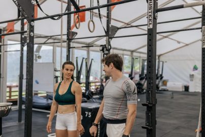 Man and woman exercising at an indoor gym, focused on fitness goals.