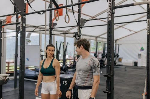 Man and woman exercising at an indoor gym, focused on fitness goals.