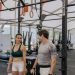 Man and woman exercising at an indoor gym, focused on fitness goals.